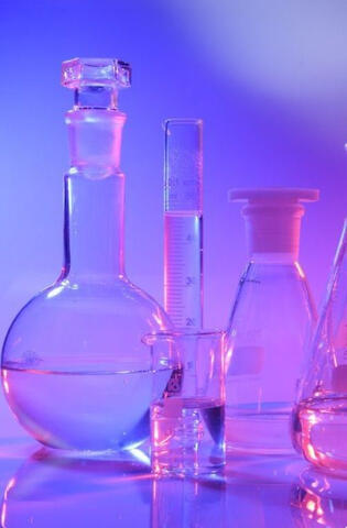 an image of lab glassware with a purple glow